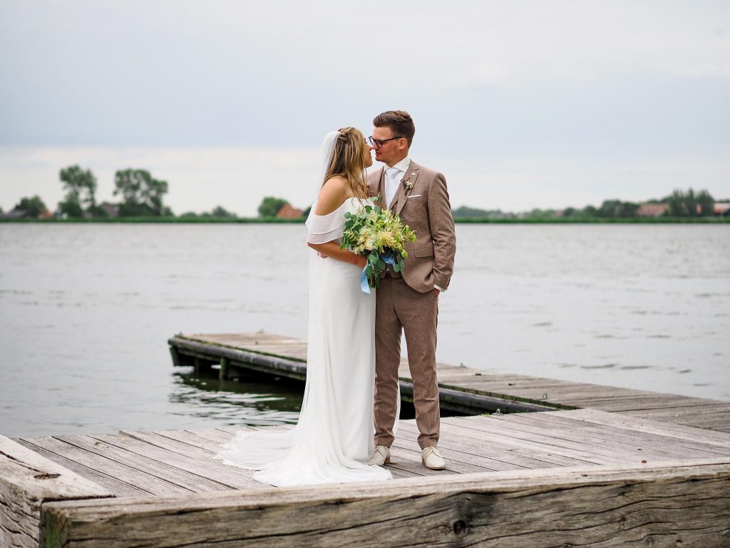 Bruidspaar poseert op een pier