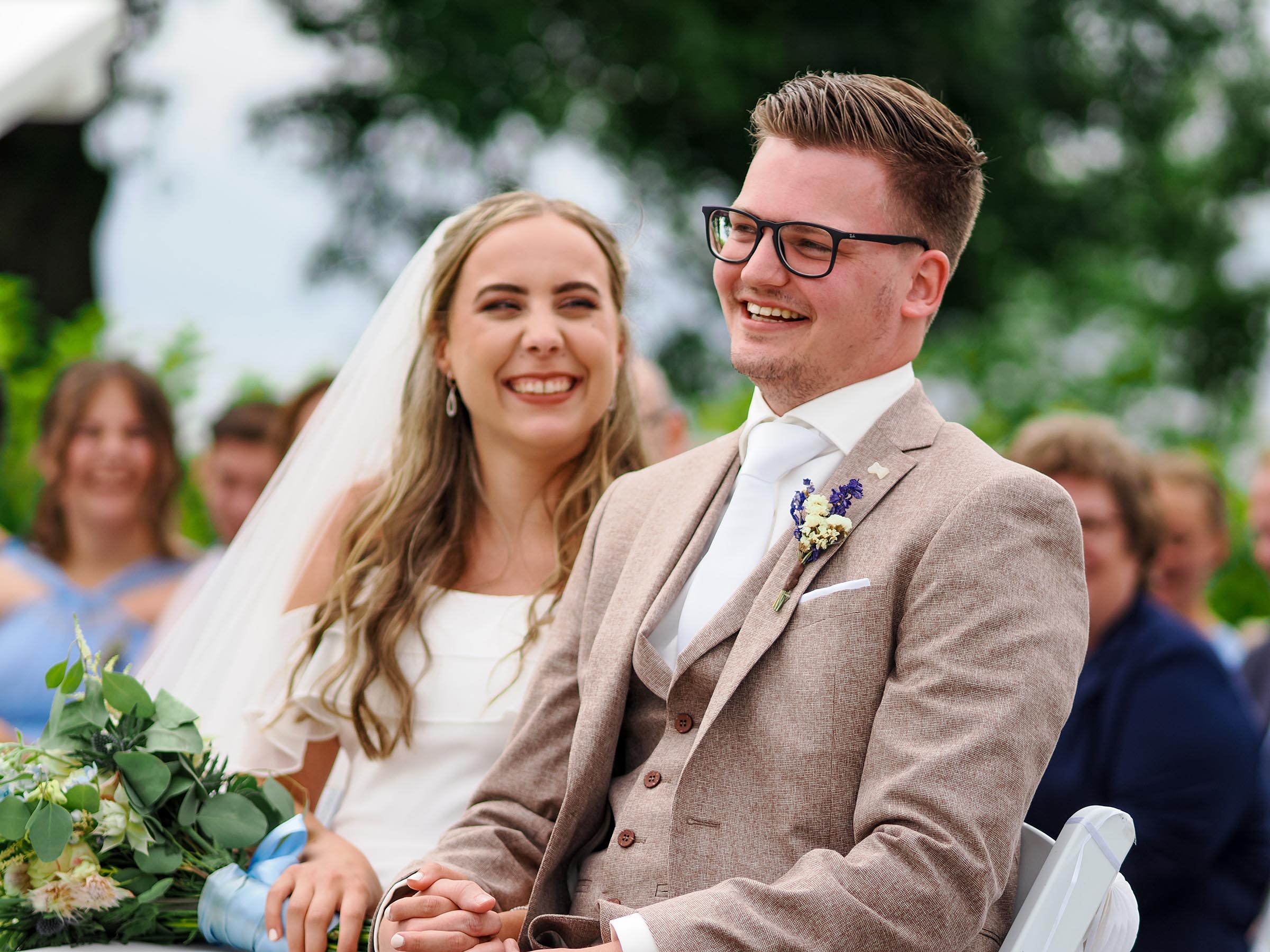 Bruidspaar lacht tijdens de ceremonie